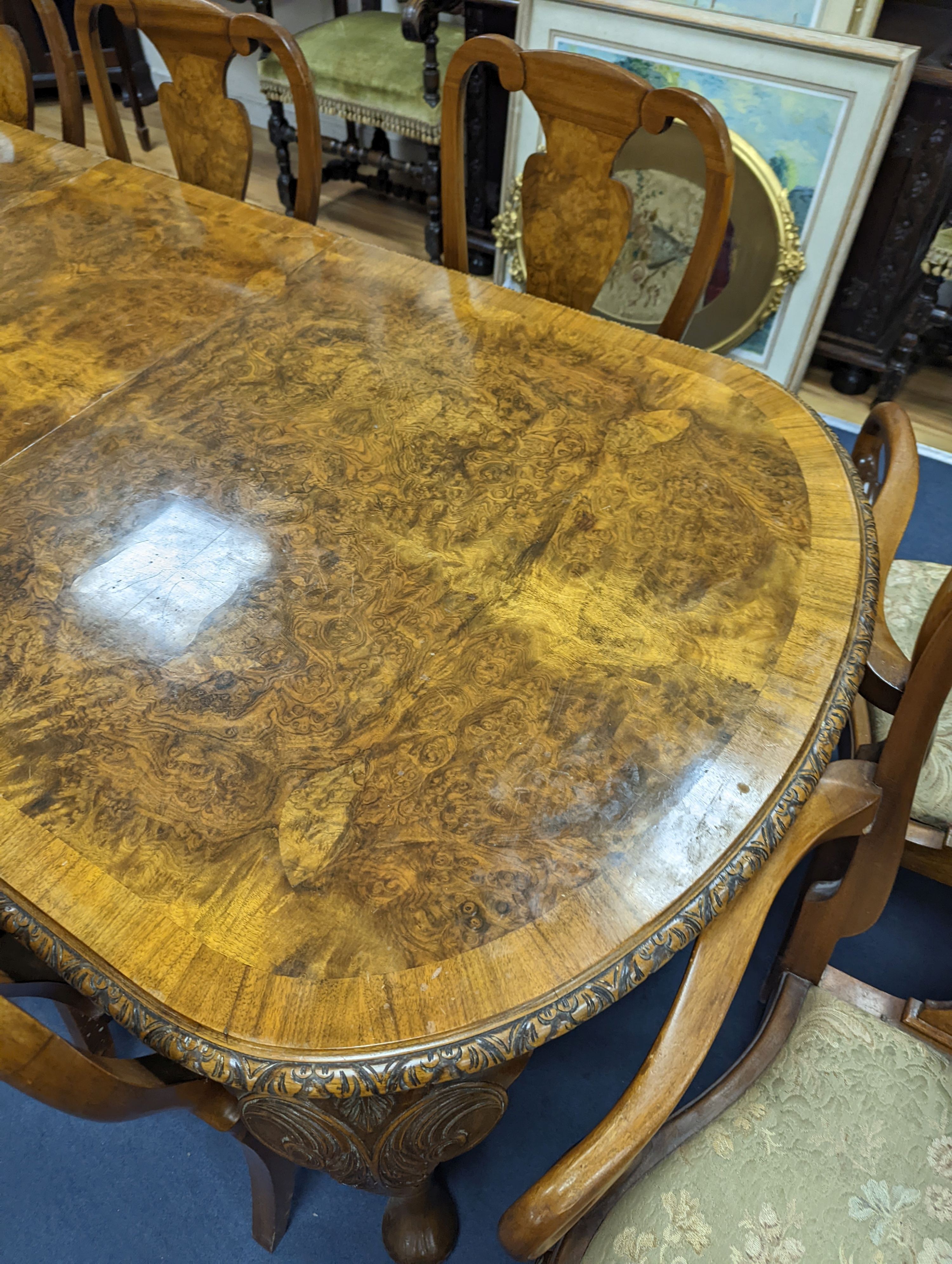 A Queen Anne revival burr walnut dining suite, comprising serpentine sideboard, length 168cm, depth 56cm, height 98cm, extending dining table, 210cm extended, one spare leaf, width 90cm, height 75cm and eight chairs, two
